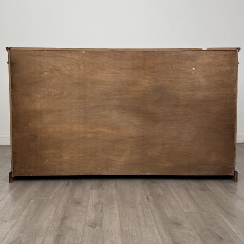fig 5. A large 20th-century dark mahogany open bookcase featuring two wide bays with adjustable shelving and a solid plinth base.