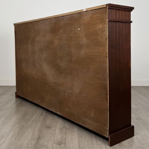 fig 6. A large 20th-century dark mahogany open bookcase featuring two wide bays with adjustable shelving and a solid plinth base.