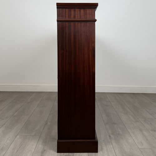 fig 7. A large 20th-century dark mahogany open bookcase featuring two wide bays with adjustable shelving and a solid plinth base.