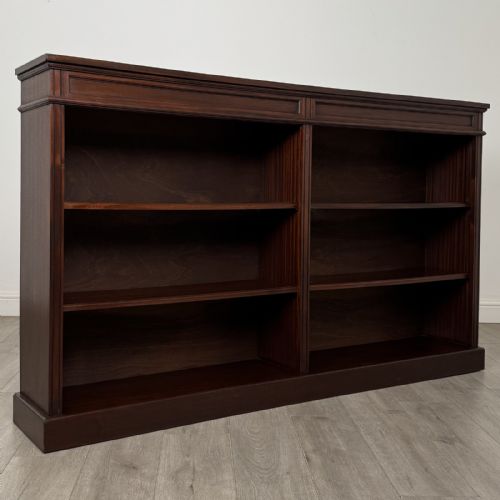 fig 8. A large 20th-century dark mahogany open bookcase featuring two wide bays with adjustable shelving and a solid plinth base.