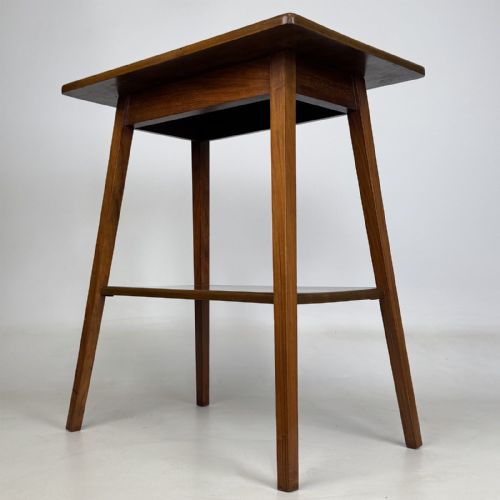 fig 1. An Edwardian figured walnut lamp table featuring a square top, lower tier shelf, and tapered splayed legs.