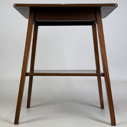 fig 4. An Edwardian figured walnut lamp table featuring a square top, lower tier shelf, and tapered splayed legs.