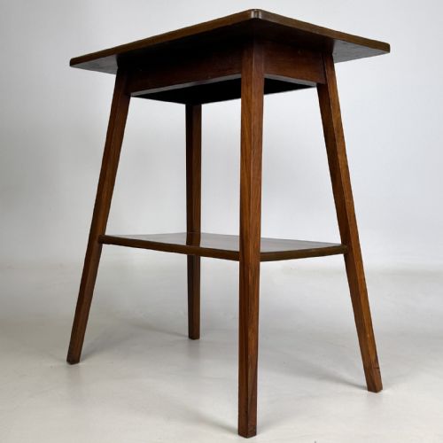 fig 5. An Edwardian figured walnut lamp table featuring a square top, lower tier shelf, and tapered splayed legs.