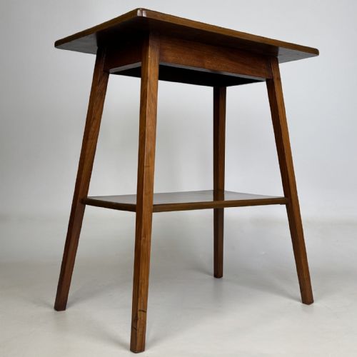 fig 7. An Edwardian figured walnut lamp table featuring a square top, lower tier shelf, and tapered splayed legs.
