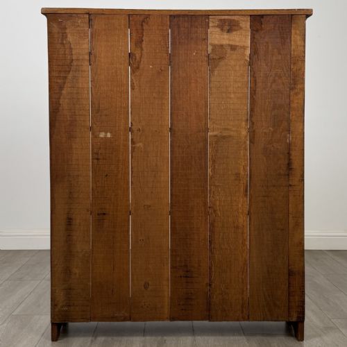 fig 4. An antique 20th-century solid oak open bookcase featuring four fixed shelves and gently shaped side panels.