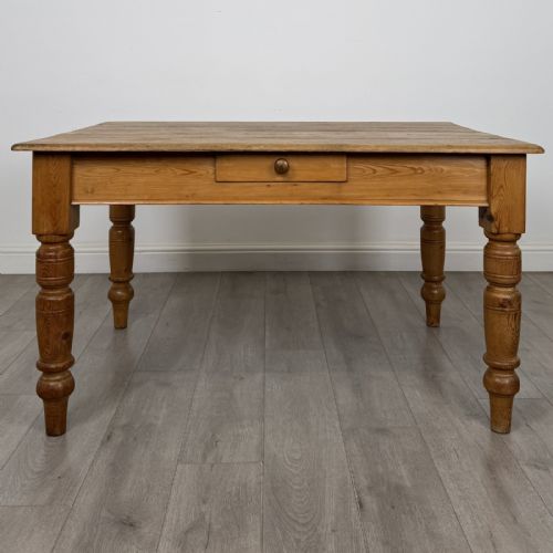 fig 1. A rectangular pine dining table with four turned legs, a planked top, and a single frieze drawer with a wooden knob.