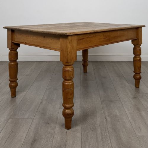 fig 3. A rectangular pine dining table with four turned legs, a planked top, and a single frieze drawer with a wooden knob.