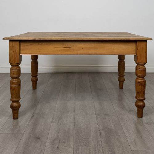 fig 4. A rectangular pine dining table with four turned legs, a planked top, and a single frieze drawer with a wooden knob.