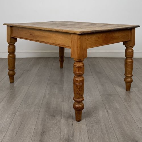 fig 5. A rectangular pine dining table with four turned legs, a planked top, and a single frieze drawer with a wooden knob.