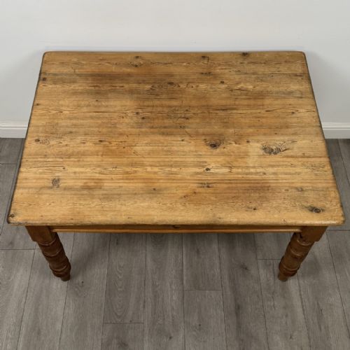 fig 8. A rectangular pine dining table with four turned legs, a planked top, and a single frieze drawer with a wooden knob.