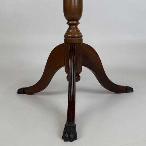 fig 4. A round dark beech tripod table featuring a turned central column, three splayed legs with claw feet, and a circular top framed by a raised spindle gallery.