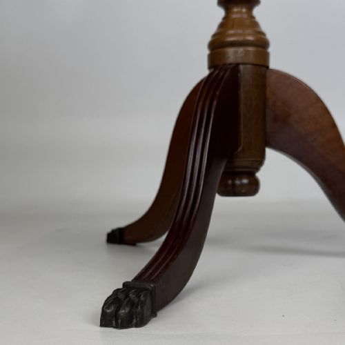 fig 5. A round dark beech tripod table featuring a turned central column, three splayed legs with claw feet, and a circular top framed by a raised spindle gallery.