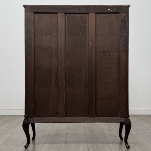 fig 4. An Edwardian dark mahogany display cabinet featuring twin astragal glazed doors and shaped cabriole legs.