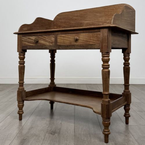 fig 1. A Victorian mahogany washstand featuring a raised rear gallery, two frieze drawers with timber knobs, turned legs, and a lower shelf.