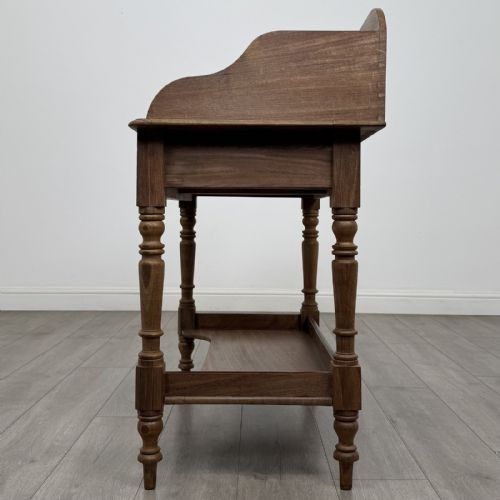 fig 2. A Victorian mahogany washstand featuring a raised rear gallery, two frieze drawers with timber knobs, turned legs, and a lower shelf.