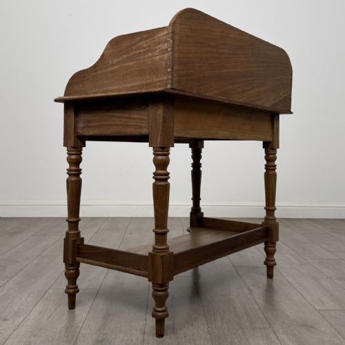 fig 3. A Victorian mahogany washstand featuring a raised rear gallery, two frieze drawers with timber knobs, turned legs, and a lower shelf.