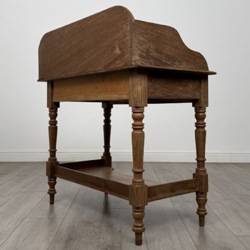 fig 5. A Victorian mahogany washstand featuring a raised rear gallery, two frieze drawers with timber knobs, turned legs, and a lower shelf.