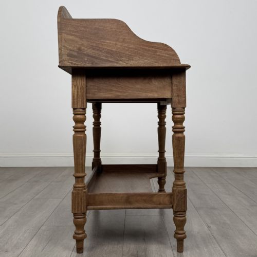 fig 6. A Victorian mahogany washstand featuring a raised rear gallery, two frieze drawers with timber knobs, turned legs, and a lower shelf.