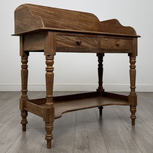 fig 7. A Victorian mahogany washstand featuring a raised rear gallery, two frieze drawers with timber knobs, turned legs, and a lower shelf.
