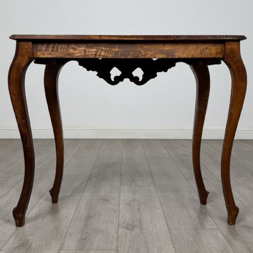 fig 4. A carved mahogany French style side table featuring exaggerated cabriole legs, a shell motif apron, and a serpentine tabletop.