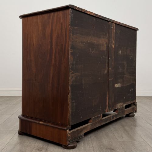 fig 3. An antique Victorian mahogany chest of drawers featuring two short drawers above three long graduated drawers with turned knobs and bun feet.