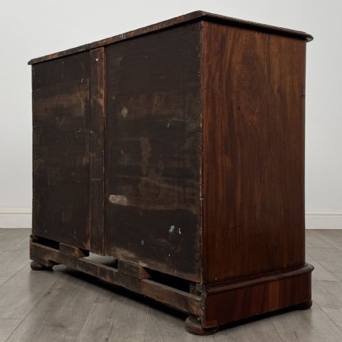 fig 5. An antique Victorian mahogany chest of drawers featuring two short drawers above three long graduated drawers with turned knobs and bun feet.