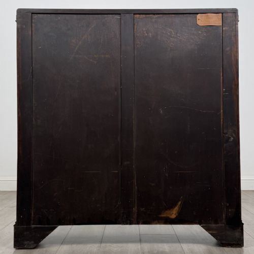fig 4. An Edwardian dark mahogany display cabinet featuring twin astragal glazed doors with Gothic tracery and bracket feet.