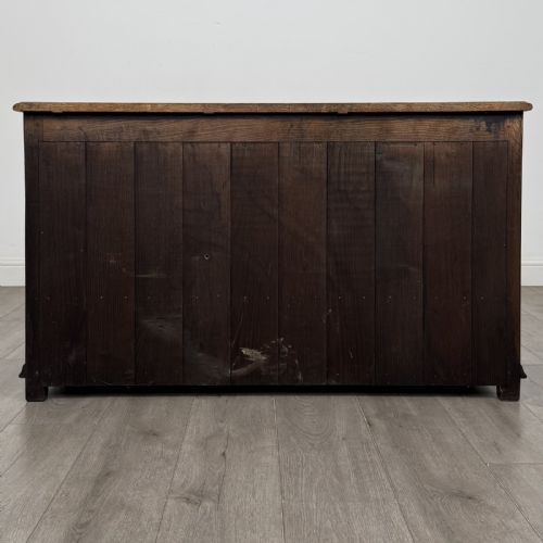 fig 4. A dark oak Georgian style drop-front mule chest featuring three arched fielded panels and two lower drawers with brass swan-neck handles.