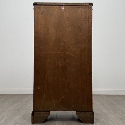 fig 5. A standing burr walnut display cabinet with a single six-pane glass door and a bracket foot base.