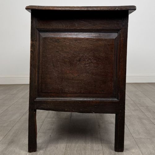 fig 2. An antique early 18th-century panelled oak coffer featuring a carved frieze with initials D H and the year 1723.