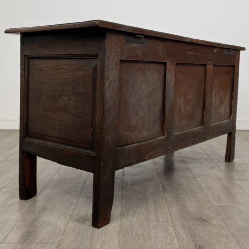 fig 3. An antique early 18th-century panelled oak coffer featuring a carved frieze with initials D H and the year 1723.