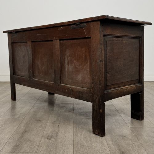 fig 5. An antique early 18th-century panelled oak coffer featuring a carved frieze with initials D H and the year 1723.