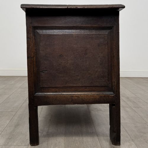 fig 6. An antique early 18th-century panelled oak coffer featuring a carved frieze with initials D H and the year 1723.