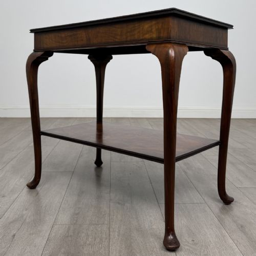 fig 1. An Edwardian burr walnut side table featuring cabriole legs, pad feet, a lower shelf, and a rectangular top with deep apron.