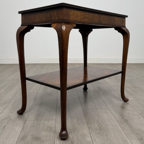 fig 3. An Edwardian burr walnut side table featuring cabriole legs, pad feet, a lower shelf, and a rectangular top with deep apron.