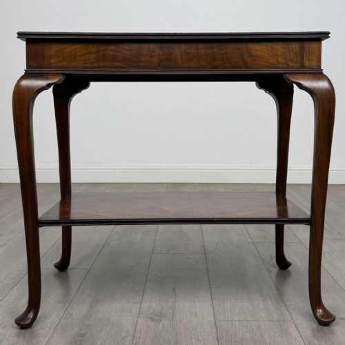 fig 4. An Edwardian burr walnut side table featuring cabriole legs, pad feet, a lower shelf, and a rectangular top with deep apron.
