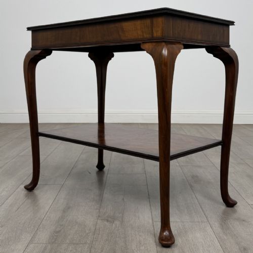 fig 5. An Edwardian burr walnut side table featuring cabriole legs, pad feet, a lower shelf, and a rectangular top with deep apron.