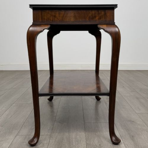 fig 6. An Edwardian burr walnut side table featuring cabriole legs, pad feet, a lower shelf, and a rectangular top with deep apron.