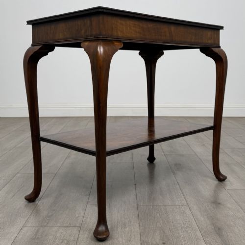 fig 7. An Edwardian burr walnut side table featuring cabriole legs, pad feet, a lower shelf, and a rectangular top with deep apron.