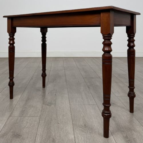 fig 1. An Edwardian walnut side table featuring a rectangular top, plain apron, and four reeded turned legs.