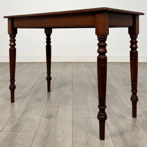 fig 5. An Edwardian walnut side table featuring a rectangular top, plain apron, and four reeded turned legs.