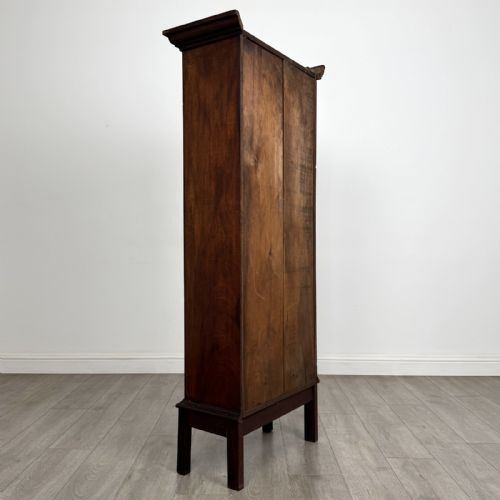fig 3. A tall, narrow Georgian mahogany display cabinet featuring a single geometric astragal glazed door and internal fabric-lined shelves.