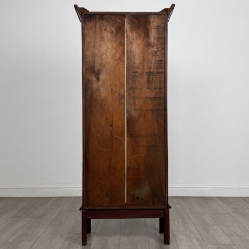 fig 4. A tall, narrow Georgian mahogany display cabinet featuring a single geometric astragal glazed door and internal fabric-lined shelves.