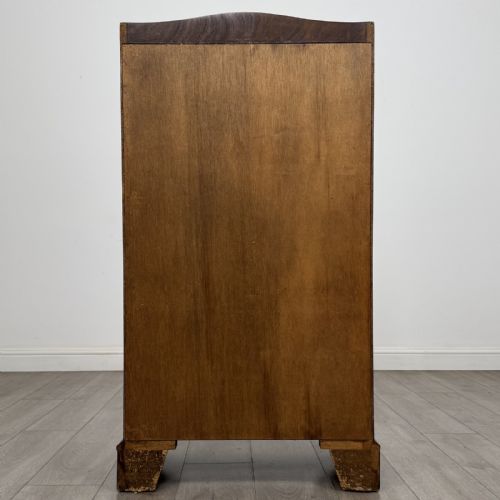 fig 4. A mahogany open bookcase featuring two upper shelves with shaped side galleries above a two-door lower cupboard on bracket feet.