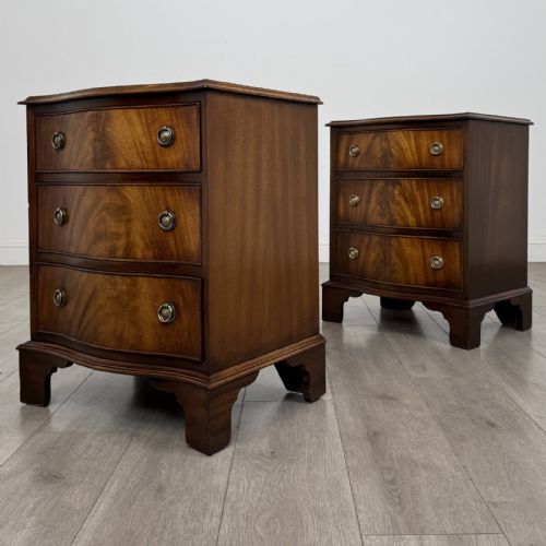 fig 2. A matching pair of Georgian style mahogany bedside chests with serpentine fronts, three drawers each, brass ring handles, and bracket feet.
