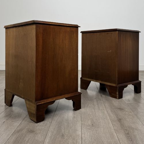fig 6. A matching pair of Georgian style mahogany bedside chests with serpentine fronts, three drawers each, brass ring handles, and bracket feet.