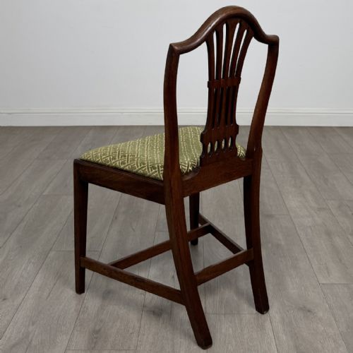 fig 2. A set of four 18th-century Georgian mahogany dining chairs featuring carved pierced back splats and green patterned upholstered seats.