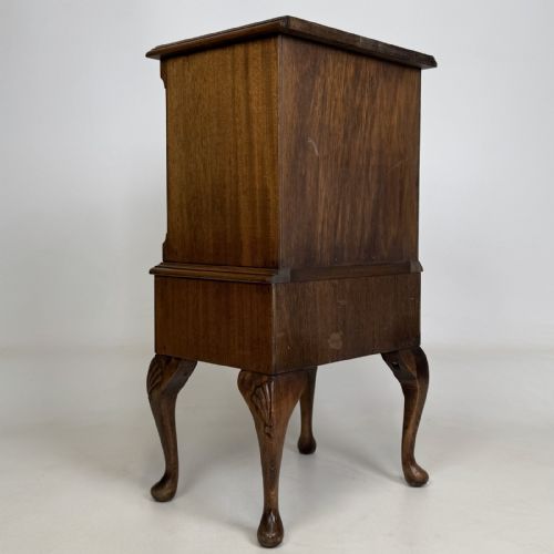 fig 3. A tall mahogany chest of drawers featuring four stacked drawers with brass handles, resting on carved cabriole legs with pad feet.