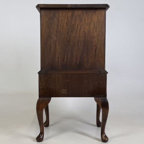fig 4. A tall mahogany chest of drawers featuring four stacked drawers with brass handles, resting on carved cabriole legs with pad feet.