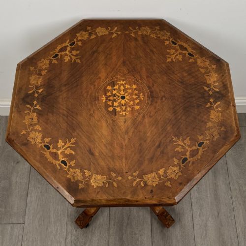 fig 4. A Victorian octagonal walnut side table featuring turned support columns, a central finial, and carved splayed legs with castors.